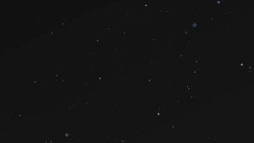 Blue, violet and white particles distributed on a dark canvas.
